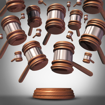 Class action lawsuit concept as a plaintiff group represented by many judge mallets or gavel icons coming down as a symbol for social litigation or organized legal legislation.