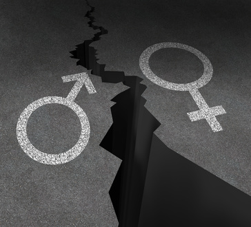 Gender gap and sex inequality concept  as a male and female symbol painted on an asphalt road that is cracked in two as a metaphor for pay or wages inequity or divorce.